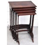 A nest of four early 20th century mahogany occasional tables on ring turned supports, largest