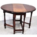 A twentieth century mahogany drop leaf table on turned legs, 70 x 105 cm when extended.