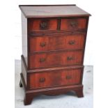 A 20th century mahogany two short over three long chest of drawers of small proportions on bracket