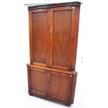 A mid 20th century oak corner unit two doors to the top with three interior shelves over two doors