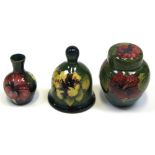 A Moorcroft Hibiscus on dark green ground ginger jar with cover, height 11cm,