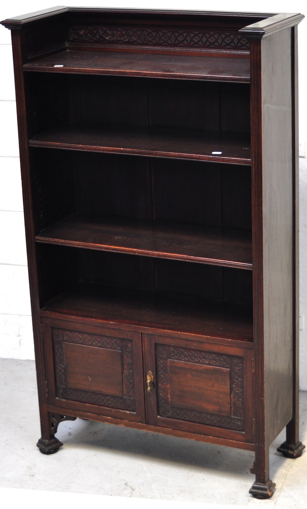 An Arts and Crafts style bookcase with two doors to base,