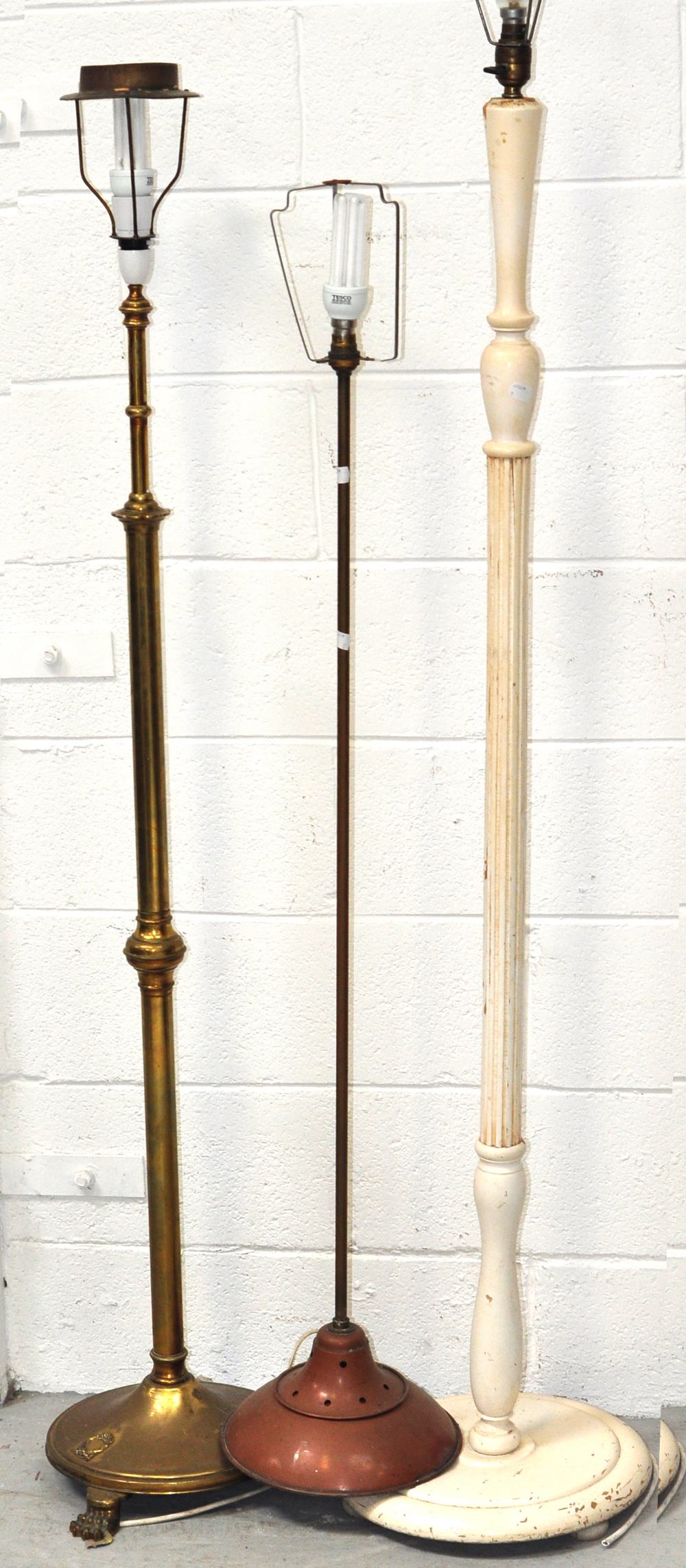 A brass standard lamp, a copper standard lamp and a wooden table lamp (3).