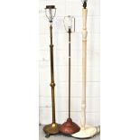 A brass standard lamp, a copper standard lamp and a wooden table lamp (3).