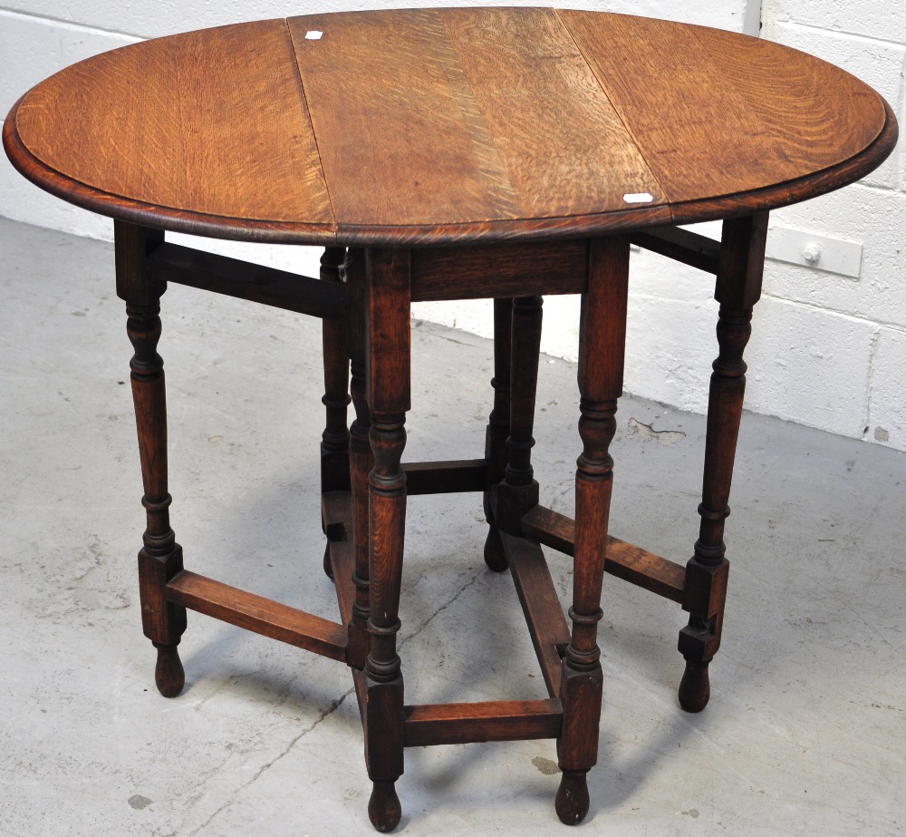 An oak drop leaf side table on turned legs and stretchers, - Image 2 of 2