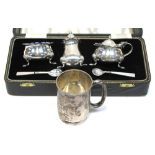 A cased Queen Elizabeth II hallmarked silver cruet set, Birmingham 1969 and a George V hallmarked
