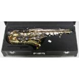 A cased Danor Alto saxophone complete with a modern metronome, music stand and playing booklets,