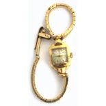 A ladies 9ct gold Omega Cordette style wristwatch, the square dial set with gilt batons, on a 9ct