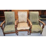 Two early 20th century reclining elbow chairs raised on bun feet and a further upholstered elbow