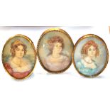 UNATTRIBUTED; three watercolour portrait miniatures, all depicting young ladies in dress,