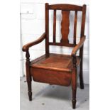 An early 20th century beech commode chair with rattan seat on ring tuned front legs.