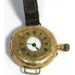 A Continental 14ct gold wristwatch, the enamel dial set with Roman numerals on leather strap (af),