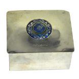 A white metal cigarette box with circular enamel motif, bearing the inscription "S.S.