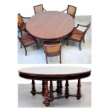 A late 19th century circular mahogany dining table supported on ring turned legs with six cane