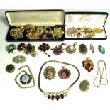 A large quantity of costume jewellery to include vintage diamante brooches, rings,