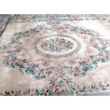 A beige ground Chinese super wash carpet of large proportions,