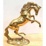 A brass figure of a rearing horse on a rocky plinth, height approx 38cm.