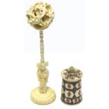 An ivory puzzle ball on a stand and a small ivory pot decorated with flowers in ink (2).