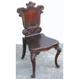 A Victorian mahogany hall chair with shield back.