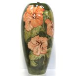 A Moorcroft Hibiscus on green ground lamp, height 40cm.