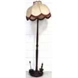 A mahogany turned standard lamp, a small wooden table lamp and one other (3).