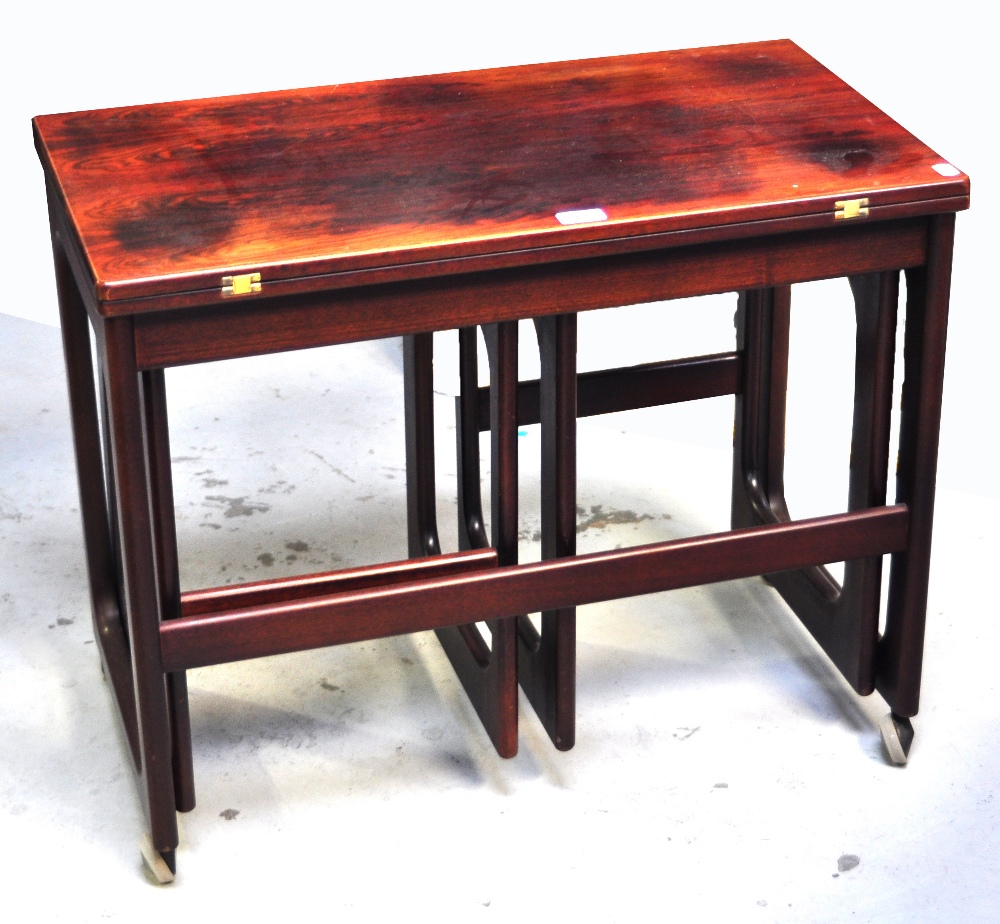 A nest of three 1960s rosewood tables, largest on wheels, width 74cm. - Image 2 of 2