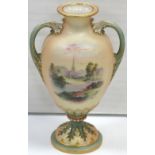 A Royal Worcester blush ivory, green and gilt heightened twin handle baluster vase on a pedestal