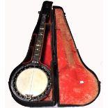 A cased "G" banjo.