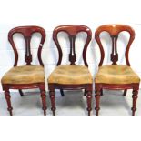 Three matching Victorian mahogany chairs, each with central carved panels (3).