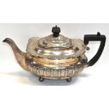 An Edward VII hallmarked silver teapot on bun feet, Sheffield height 24.5ozt, length 32cm.