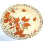 A Charlotte Rhead Crown Ducal charger decorated with autumn leaves, Crown Ducal marks to the back,
