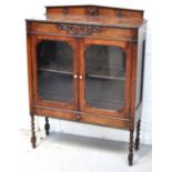 An Early 20th century bookcase with glazed doors,