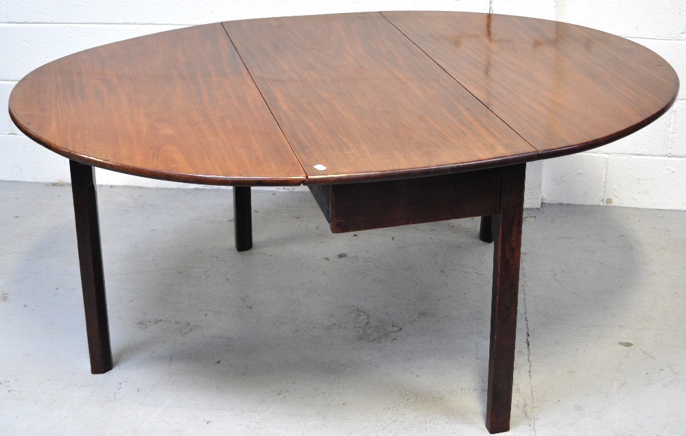 A George III mahogany oval drop leaf dining table, length 160cm.