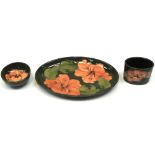 Three pieces of Moorcroft Hibiscus on green ground to include an oval dish, diameter 25cm,