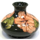 A Moorcroft Hibiscus on green ground squat baluster vase,