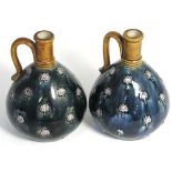 A pair of Art Nouveau Royal Doulton jugs, initialled to the underside "M.