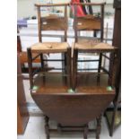 An early 20th century oak drop leaf table with barley twist supports,