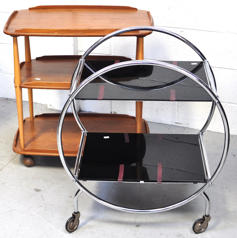 A retro light oak Ercol three tier trolley and another retro chromed example (2).