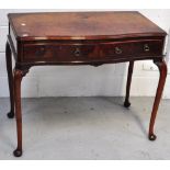 A reproduction walnut serpentine front hall table with two drawers on cabriole legs,