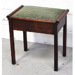 An early 20th century mahogany single piano stool with green lift up upholstered seat pad,