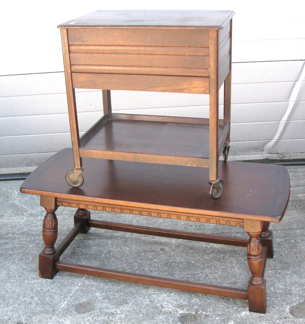 An oak occasional table and an oak sewing table on castors (2).