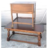 An oak occasional table and an oak sewing table on castors (2).