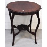 An early 20th century shaped side table on cabriole legs, with lower smaller shaped shelf,