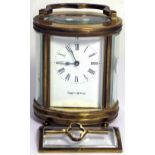 A Mappin and Webb oval eight day brass carriage clock, the enamel dial set with Roman numerals (af).