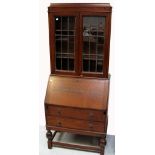 A 20th century oak bureau bookcase of small proportions, height 185cm.