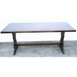 A large oak trestle style dining table, length 184cm.