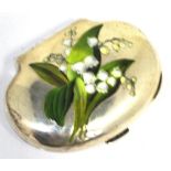 A Victorian hallmarked silver purse of oval form, the top set with enamel lily of the valley,