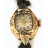 A ladies 14ct gold Bulova wristwatch, the dial set with gilt Arabic numerals on a Cordette strap,