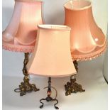 A pair of brass table lamps with pink silk shades and one other metal table lamp (3).