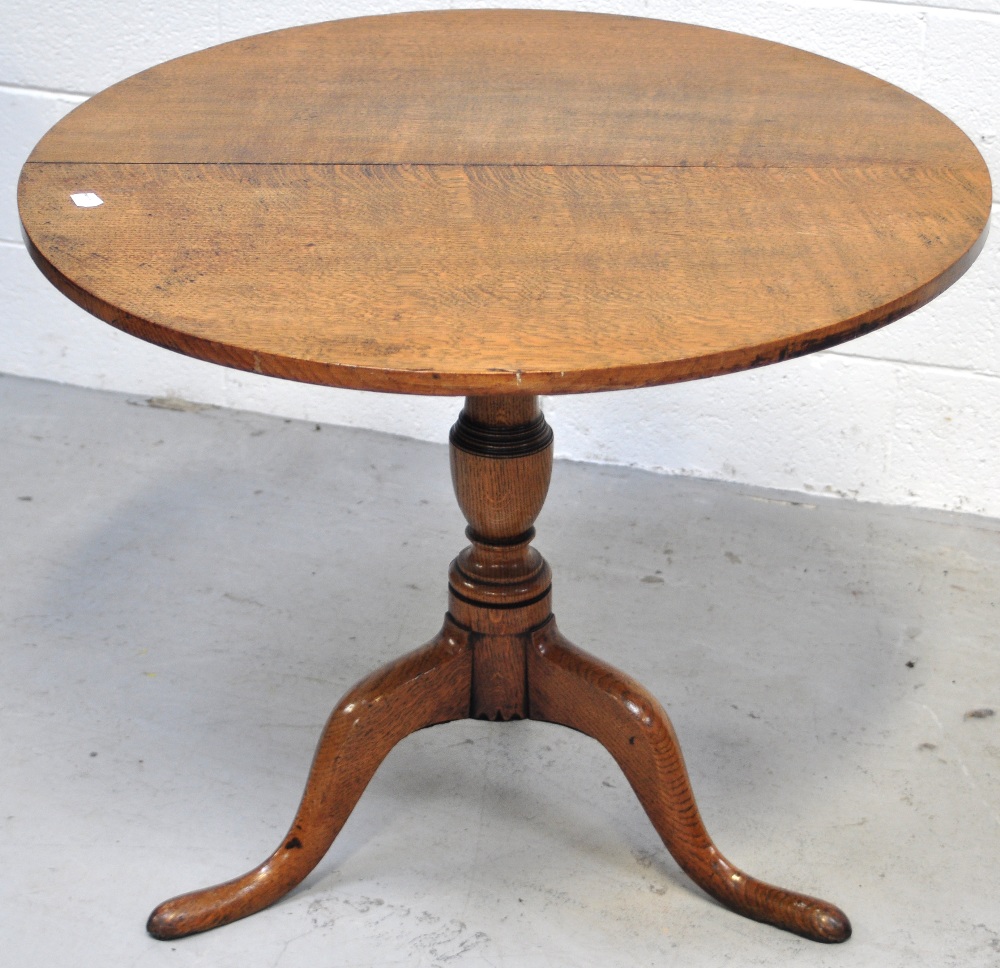 An early 19th century oak tripod occasional table, diameter 79cm.